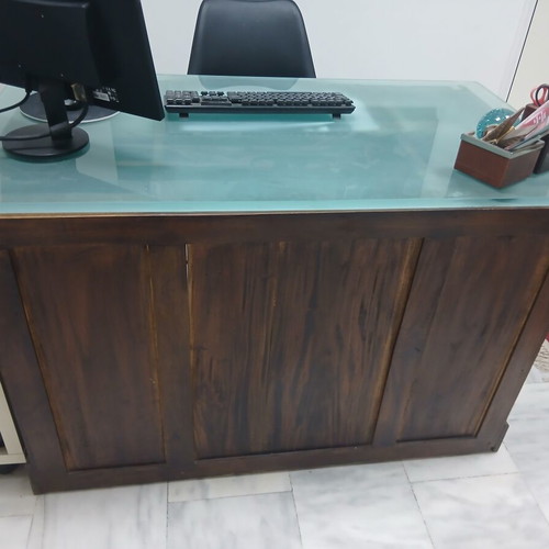 Desk made of walnut wood with green glass top and six drawers used