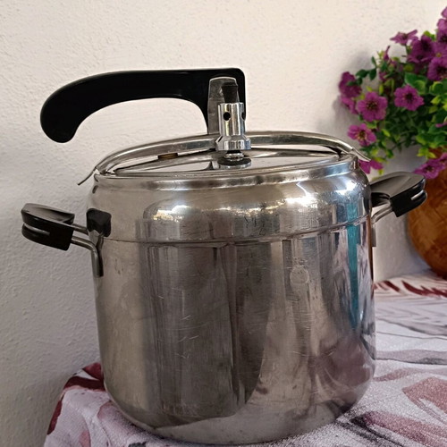 Pressure cooker used, old style, stainless steel with safety lid