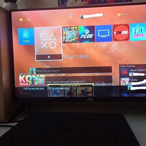PlayStation 4 Slim 1TB console with red DualShock 4 and charging dock