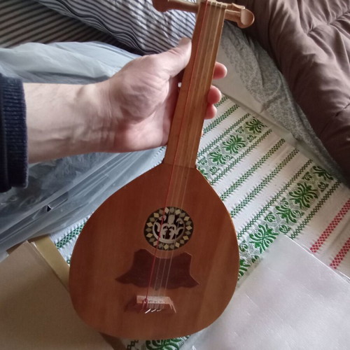Mini tambouras used, wooden with crack