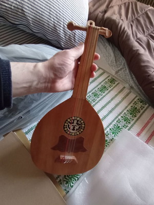 Mini tambouras used, wooden with crack