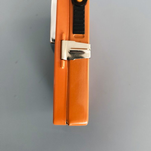 Vintage orange flat pocket flashlight used with retro UCAR battery