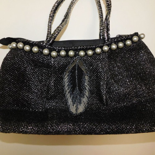 Handheld straw bag metallic like new with feather design and pearl accessory