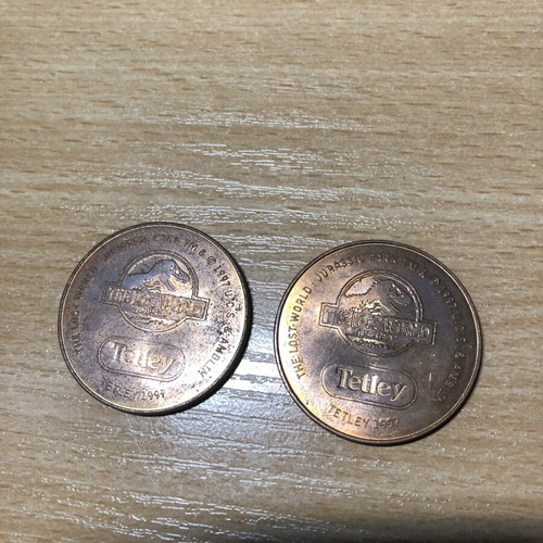 Jurassic World Tetley Velociraptor and Pteranodon coins, 38mm