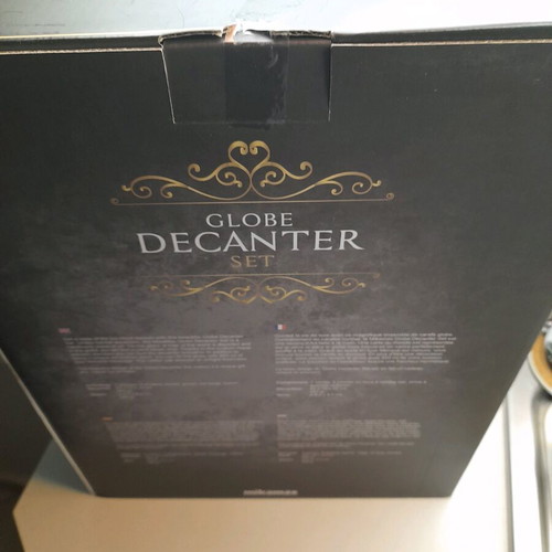 Glass decanter with globe design and accessories, new