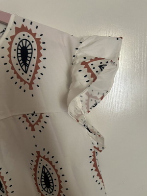 Dress with eye motifs and ruffles on sleeves and hem one size new