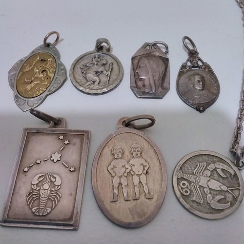 Silver pendant necklace used with zodiac and catholic figures