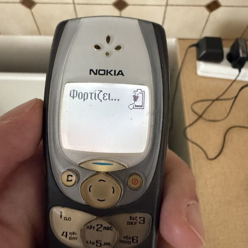 Nokia 2300 mobile phone with charger and headphones