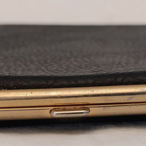 Classic cigarette case used, black leatherette with bronze interior
