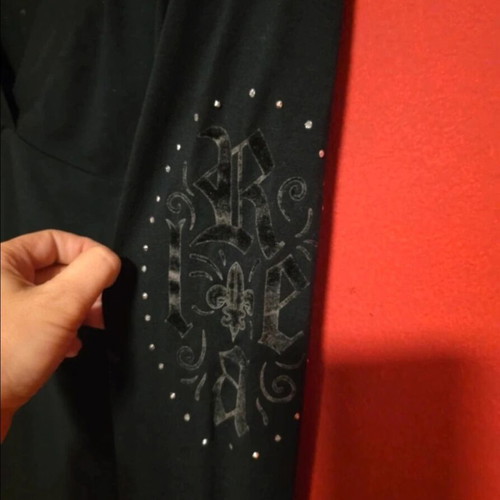 Black top with prints and rhinestones like new