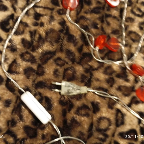 Heart-shaped string lights used with power, white cable