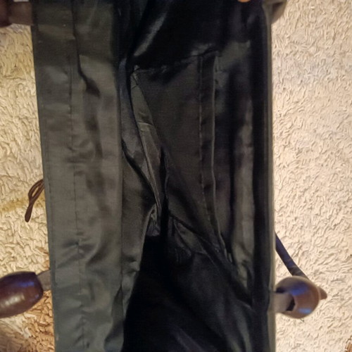 Wooden bag with slightly faded strap