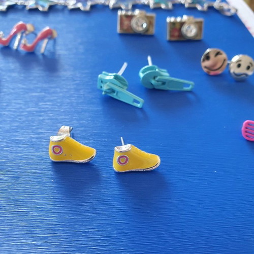 Unique earrings used with designs of swimsuits, rackets, sunglasses