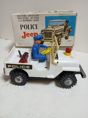 Vasileiadis battery toy used with police officer in Jeep
