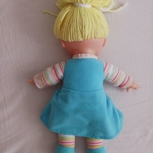 Doll with blonde yarn hair like new, soft body