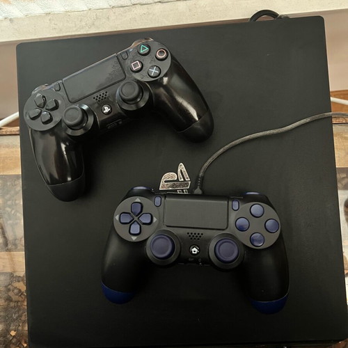 PS4 Pro 1TB console used with two controllers