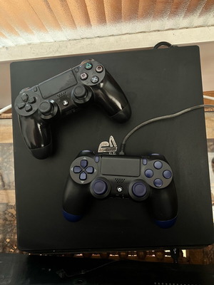PS4 Pro 1TB console used with two controllers