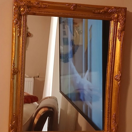 Wooden mirror with golden patina