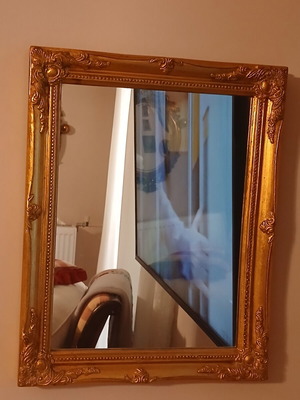 Wooden mirror with golden patina
