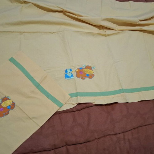 Nef Nef yellow crib sheet used with pillowcase
