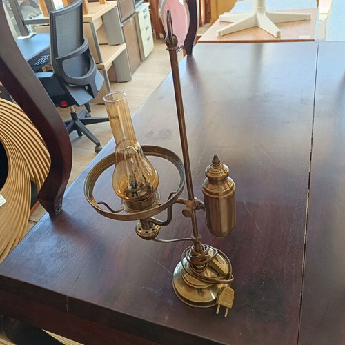 Retro table lamp made of brass used, oil lamp style with amber glass chimney