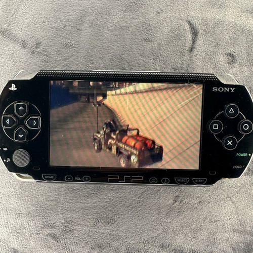 PlayStation Portable PSP-1000 used with charger, 5 games, and Memory Stick