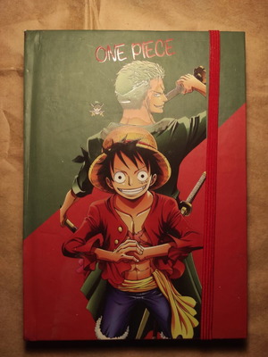One Piece συλλεκτικό σημειωματάριο με λάστιχο και Luffy και Zoro