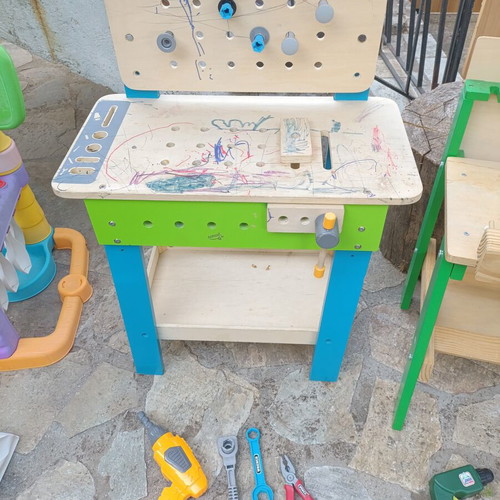 Children's wooden workbench used with tools