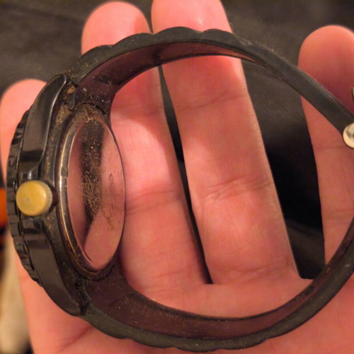 Black wristwatch used, needs battery
