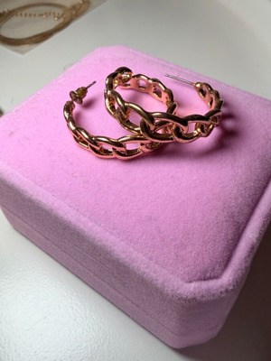 Gold-colored hoop earrings used, one clasp missing, with designs