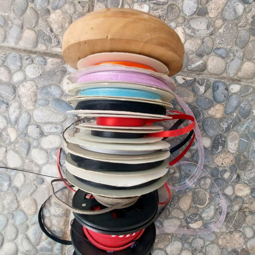 Wooden base with ribbons used for jewelry