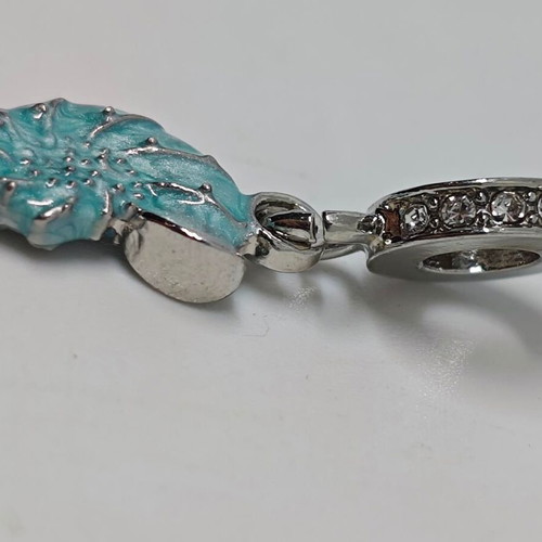 Silver charm with blue enamel Nautilus like new