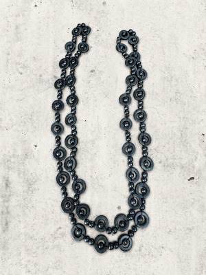 Minimal black statement necklace used with geometric design