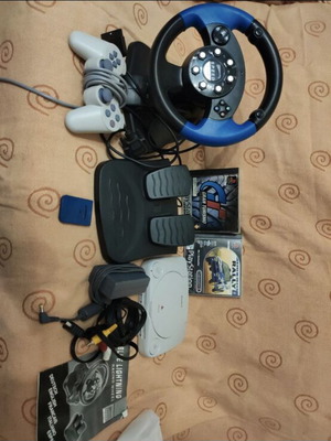 PlayStation 1 with steering wheel and 2 games, excellent condition