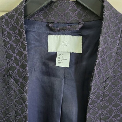 Black H&M jacket with three-quarter sleeve and purple embroidery size medium like new