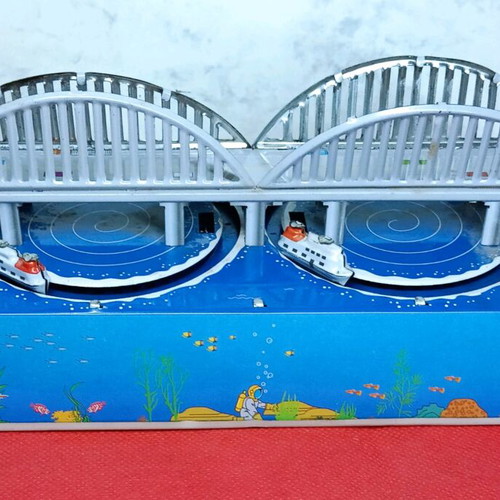 Tin wind-up toy used with key and moving boats