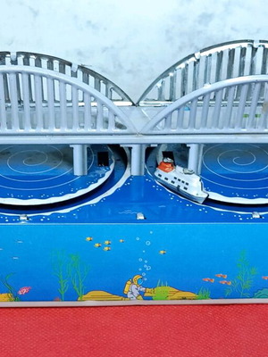 Tin wind-up toy used with key and moving boats