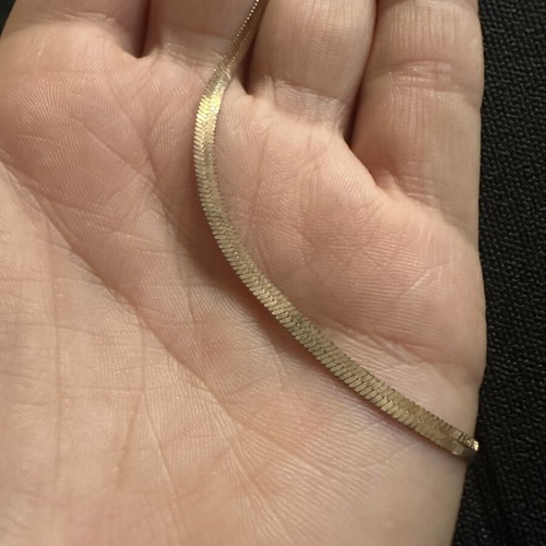 Gold plated bracelet snake chain herringbone style, worn with oxidation spots