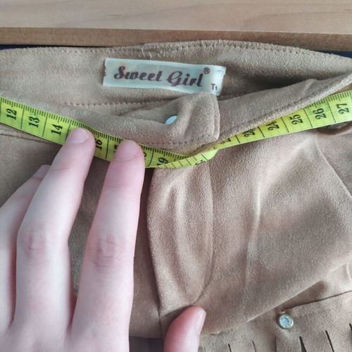 Skirt used with suede-type fringes and matte antique gold details