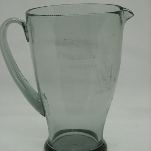 Vintage water pitcher made of blown glass used, gray with floral engravings