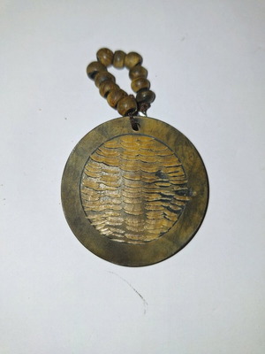 Wooden pendant like new with embossed wave details