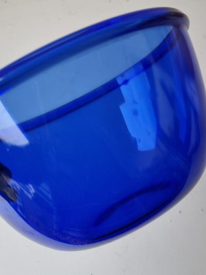Blue glass bowl with thick walls and smooth texture