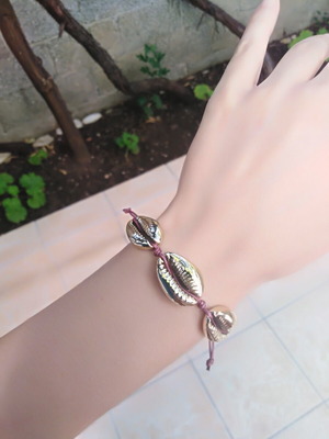 Handmade bracelet with gold metal shells and adjustable polyester cord