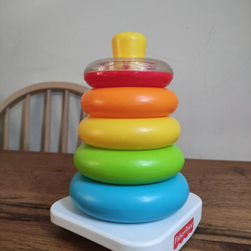 Fisher-Price stacking pyramid like new, 5 colorful rings with rattle base