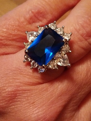 Ring with rhinestones and blue stone like new, size 17.0