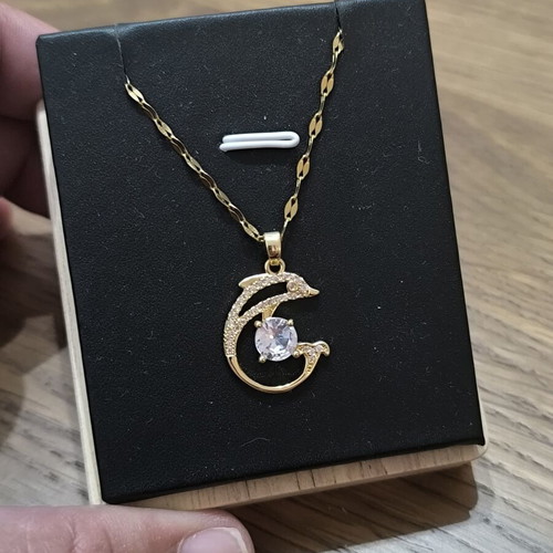 Necklace with dolphins and white stone, gold color