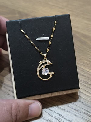 Necklace with dolphins and white stone, gold color