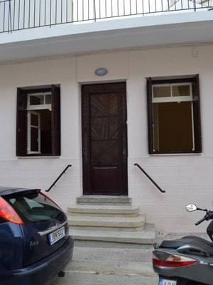 Iron exterior door used with carved wooden window shutters