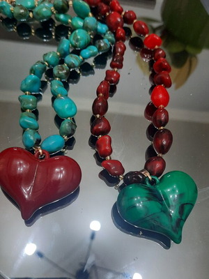 Two handmade beaded necklaces with heart pendants, red and green