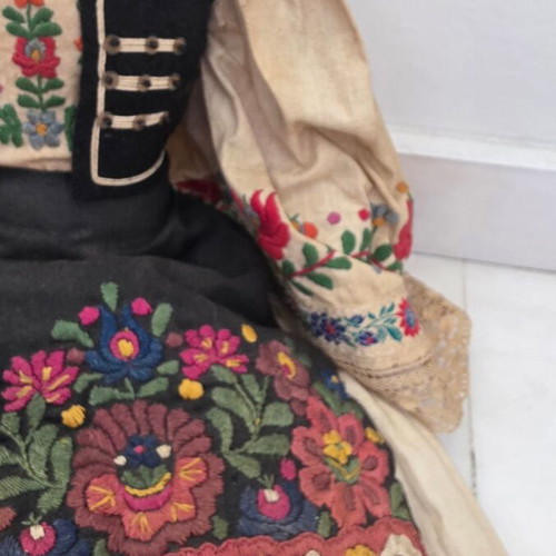 Traditional doll used with embroidered costume and hat